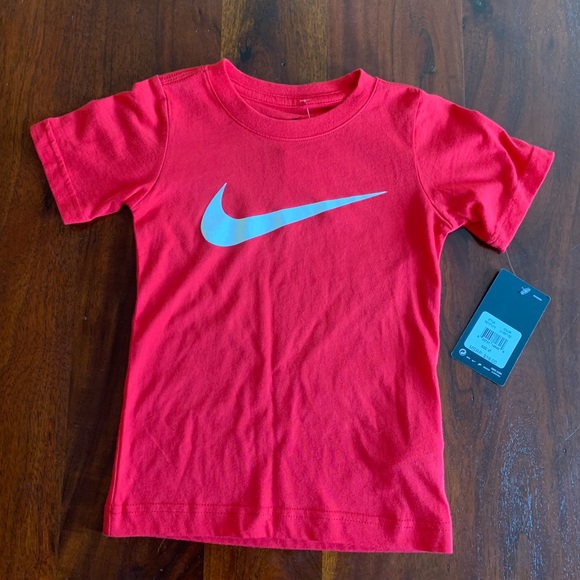 red nike shirt with white swoosh